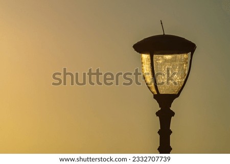 Street lamp on sunset background. Concept of design of the parks and walking streets. Maintenance of them.