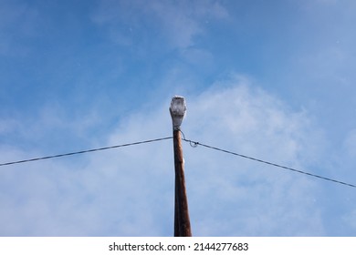 Street Lamp On Wooden Power Pole In Winter.