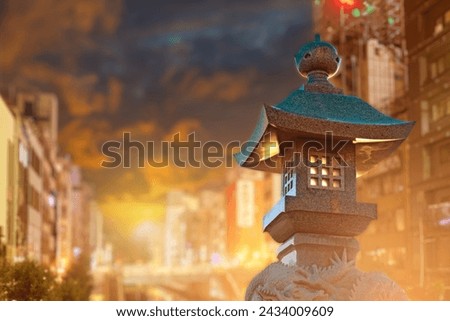 Street lamp in oriental style. Stone lantern in residential area. Street lighting equipment. Traditional oriental lantern at sunset. Stone sculpture with dragons. Lantern for lighting courtyard area