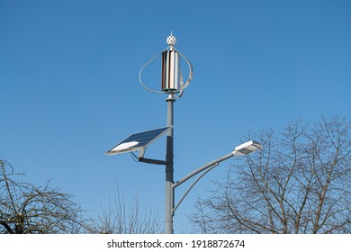 Street lamp with solar and wind energy on the roadside and blue sky in the background