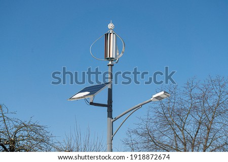 Street lamp with solar and wind energy on the roadside and blue sky in the background