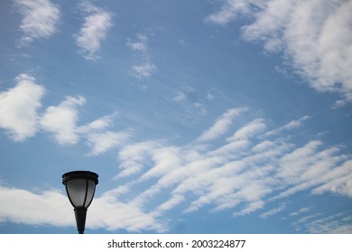 Street lamp with streaks of clouds in the background 