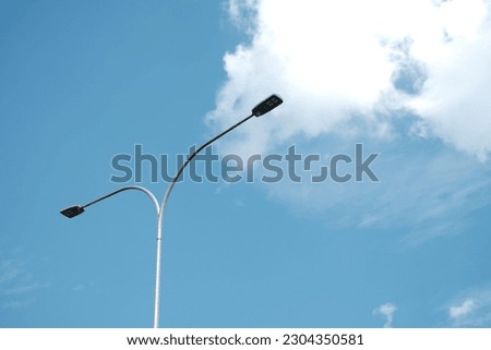 Street lamps with blue sky in background