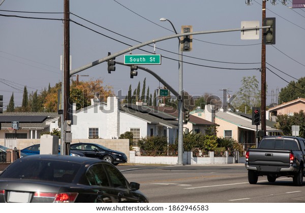 Street level day time view of the\
residential district of Lakewood, California,\
USA.