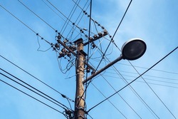 Street Light With Electricity Utility Pole And Messy Electrical Wires, Low Angle View
