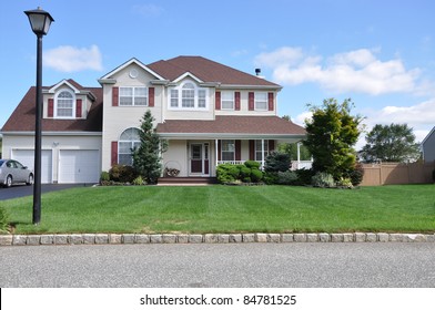 Street Light Lamp Post On Curb Of Suburban Luxury Two Story Two Car Garage Home