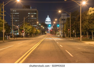 Street light and tree line leading to State Capitol of Arkansas, a scale replica of the US capitol located in Little Rock. The main house of Arkansas government, famous landmark and tourist attraction