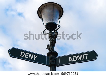 Street lighting pole with two opposite directional arrows over blue cloudy background. Deny versus Admit concept.