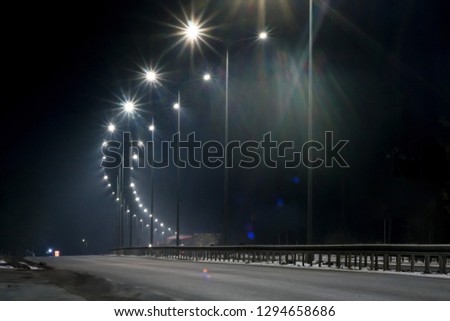 street lighting, supports for ceilings with led lamps. concept of modernization and maintenance of lamps, place for text, night. winter season. energy-saving lamps, safety of movement