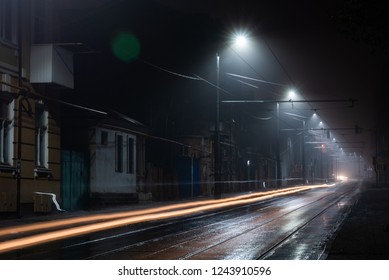 Street Lights Foggy Misty Night. Tram Route On A City Street.