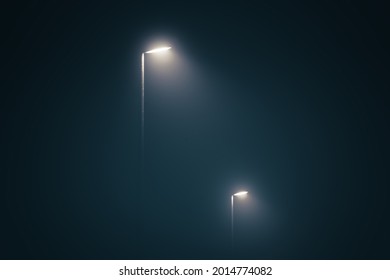 Street lights in the misty evening glowing in the dark by midnight