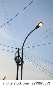Street lights and power lines in Indonesia at dawn