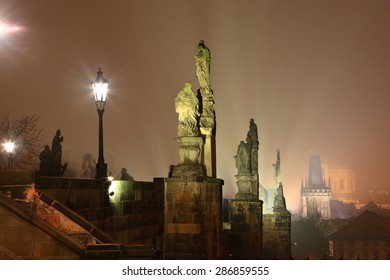 Street lights and religious statues on the Charles bridge in foggy night, Prague, Czech Republic - Shutterstock ID 286859555