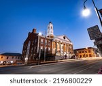 Street lights and trails of passing cars in front of Woodford County Courthouse in downtown Versailles, Kentucky during early morning hours