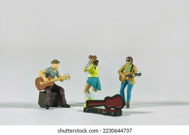 Street music band isolated on light background, miniature figures scene - Shutterstock ID 2230644737