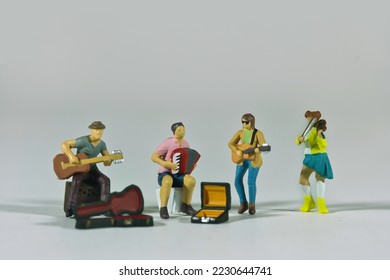 Street music band isolated on light background, miniature figures scene - Shutterstock ID 2230644741