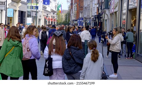 Street musician at Grafton Street Dublin - a popular place for buskers - CITY OF DUBLIN, IRELAND - APRIL 20, 2022