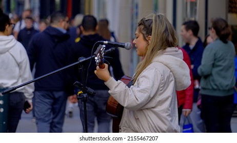 Street musician at Grafton Street Dublin - a popular place for buskers - CITY OF DUBLIN, IRELAND - APRIL 20, 2022