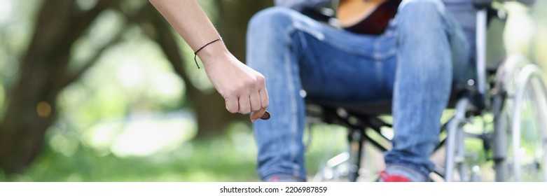 Street Musician With Guitar In Wheelchair Makes Money. Disabled Person And Poverty And Earnings Concept