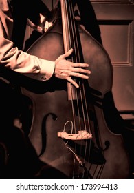 Street Musician Playing Bass Fiddle On New Orleans Street In The French Quarter..