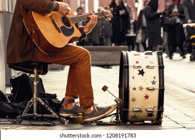 street musician, playing guitar and drums