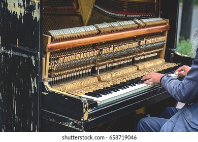 A Street Musician Playing The Old Piano