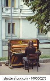 Street Musician Playing The Old Shabby Piano.