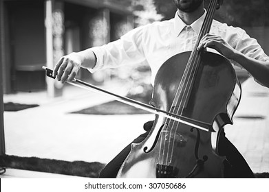 Street Musician Playing On Contrabass. Black And White Vintage  