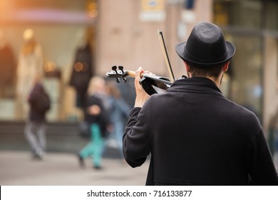 A Street Musician Playing The Violin