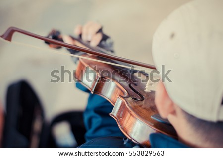 Street musician playing violin,Selective focus and tone color.