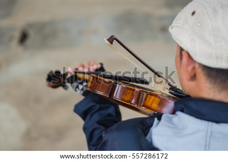 Street musician playing violin,Selective focus 