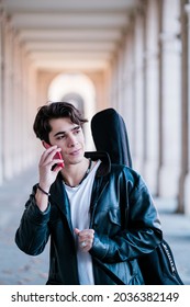 Street Musician Walking In The Street With Guitar Case. Young Handsom Man Talking By Phone Outdoors