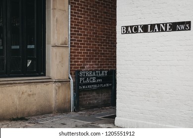 Street Name Sign On A Side Of The Building On The Corner Of Back Lane And Streatley Place, Hampstead, London, UK.