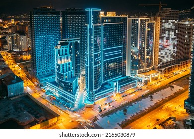 Street Night City Traffic and highrise houses . Elevated View Cityscape Skyline. Night Light Lighting. Industrial concept. Building industry.