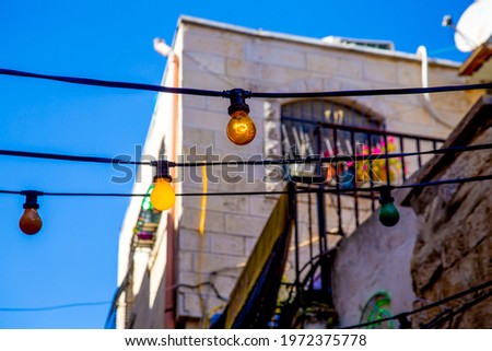 Street of the old city of Jerusalem decorated with bright multi-colored bulbs for Ramadan in the Arab quarter of Jerusalem's Old City.