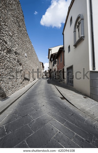 Street in a old city without\
people and cars in Italy. Narrow street in the medieval italian\
town.