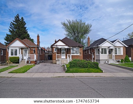 street with old fashioned 1950s style working class bungalows