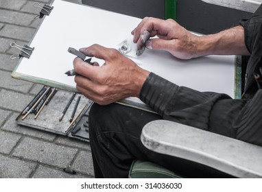 Street Painter Sketching Portrait.