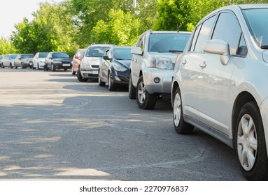 Street parking in city park. Cars parked along the street. Car Park.  - Powered by Shutterstock