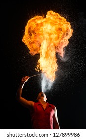 Street Performer Fire Breather Blowing on Torch