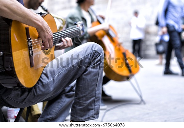 street performers\
with guitar, with audience\

