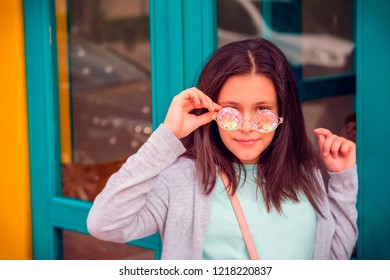 street photo with a young beautiful girl model with dark long hair in glasses kaleidoscopes - Powered by Shutterstock