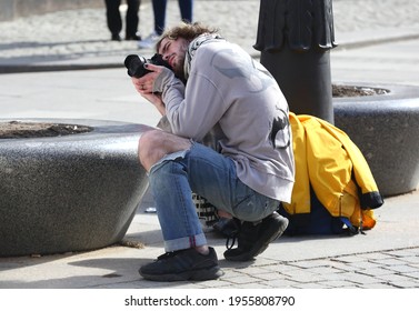 Street Photographer In Ripped Jeans At Work, Obvodny Canal Embankment, Saint Petersburg, Russia, April 2021