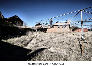 Street photography of a Hills Hoist washing line in the back of an abandoned home in Goulburn NSW Australia
