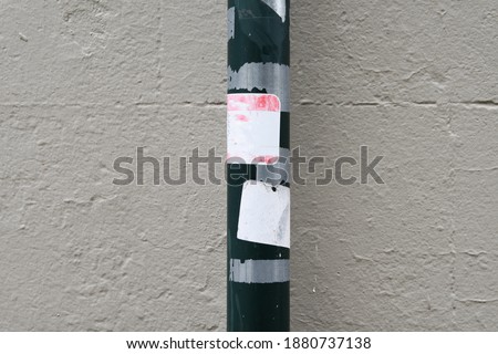 Street pole with old worn empty stickers, space for text