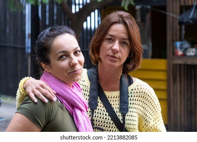 Street Portrait Of Two Women 35-40 Years Old Embracing Each Other. Concept: Female Friendship And Love, Two Friends, Long-awaited Meeting.