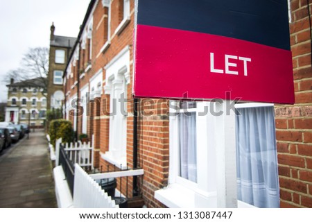 A street of red brick houses with 'Let' sign Stock fotó © 