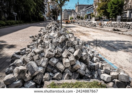 Street renovation. Heap of pavement stones. Industrial theme