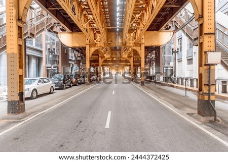 Street running under elevated tracks in downtown Chicago