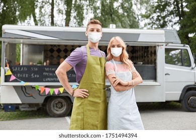 street sale and people concept - couple of young sellers wearing face protective medical mask for protection from virus disease at food truck - Powered by Shutterstock